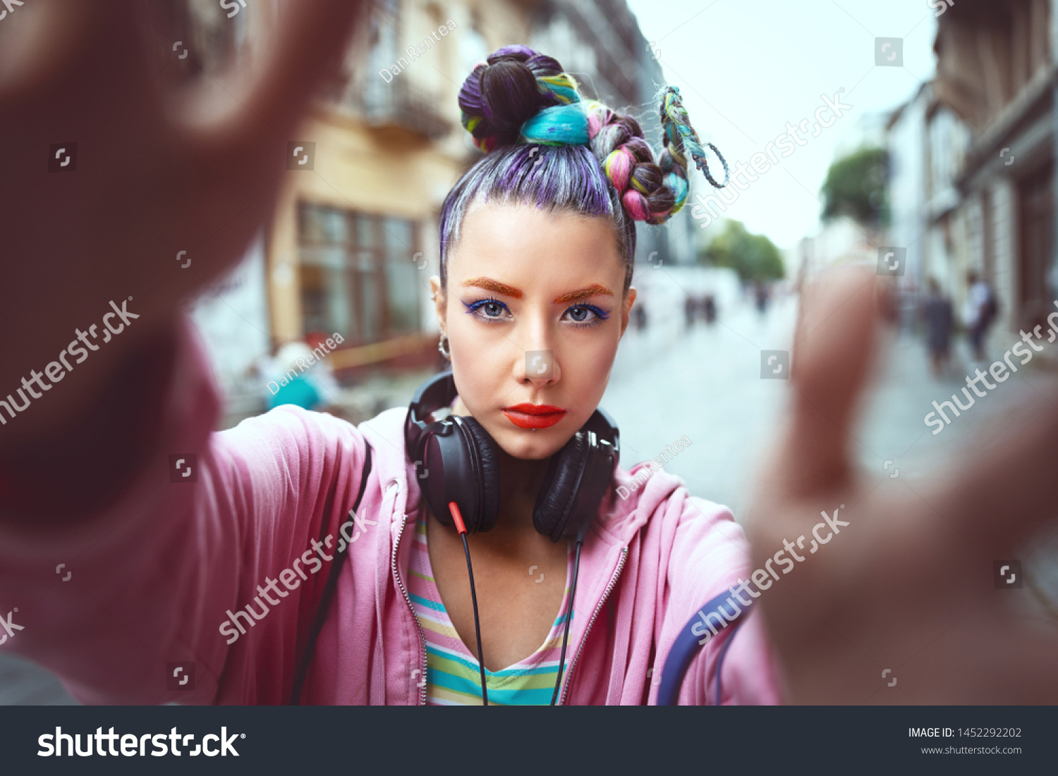 Cool funky young girl with headphones and crazy hair enjoy power of music taking selfie on street – hipster woman with trendy avant-garde look having fun - Music fan concept with playful carefree teen #1452292202
