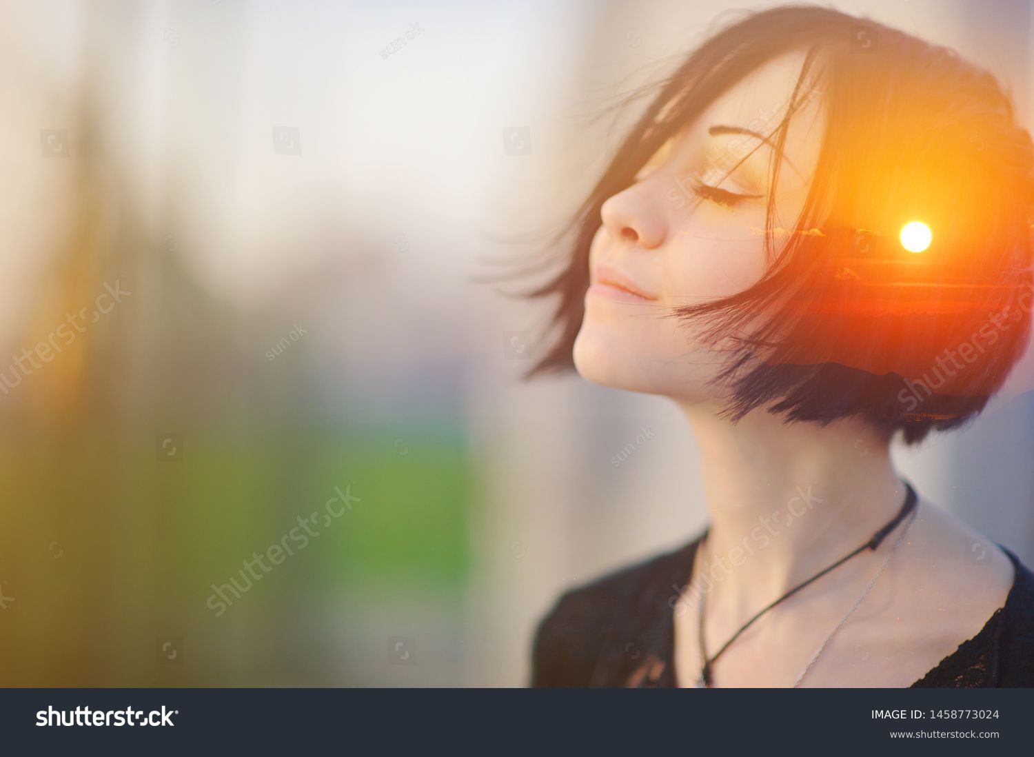 Double multiply exposure portrait of a dreamy cute woman meditating outdoors with eyes closed, combined with photograph of nature, sunrise or sunset, closeup. Psychology freedom power of mind concept #1458773024