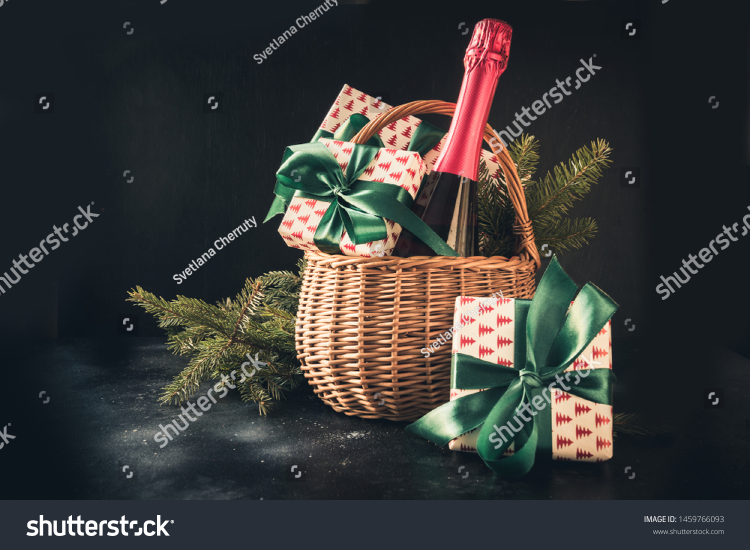 Christmas gift hamper with champagne and gift on black. Space for your greetings. Xmas. #1459766093