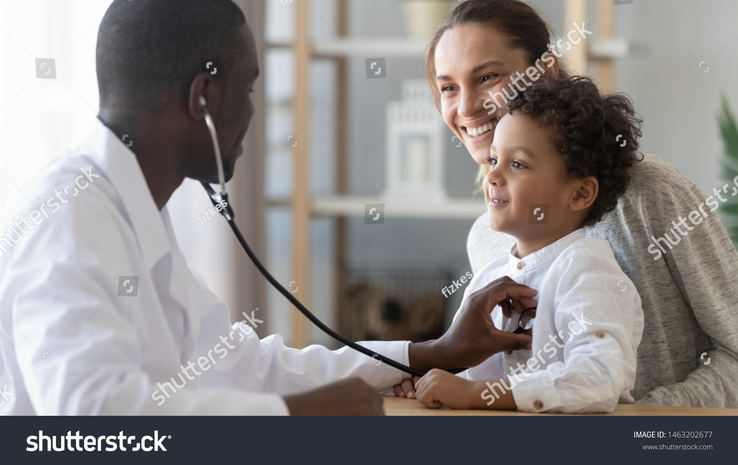 African male pediatrician hold stethoscope exam child boy patient visit doctor with mother, black paediatrician check heart lungs of kid do pediatric checkup in hospital children medical care concept #1463202677