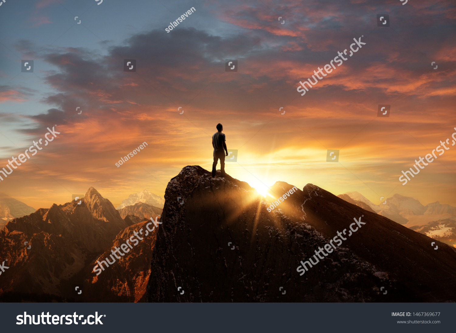 A man standing on top of a mountain as the sun sets. Goals and achievements concept photo composite. #1467369677