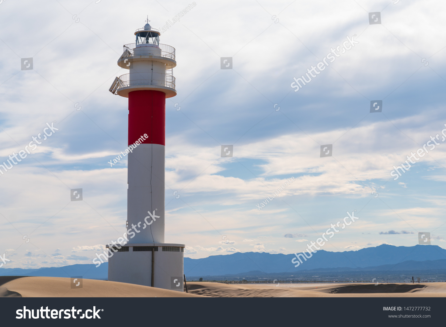 DELTA DE L'EBRE, TARRAGONA, CATALUNYA, SPAIN - JUNE 5, 2019: Beach of "punta del fangar" lighthouse "far del fangar". #1472777732