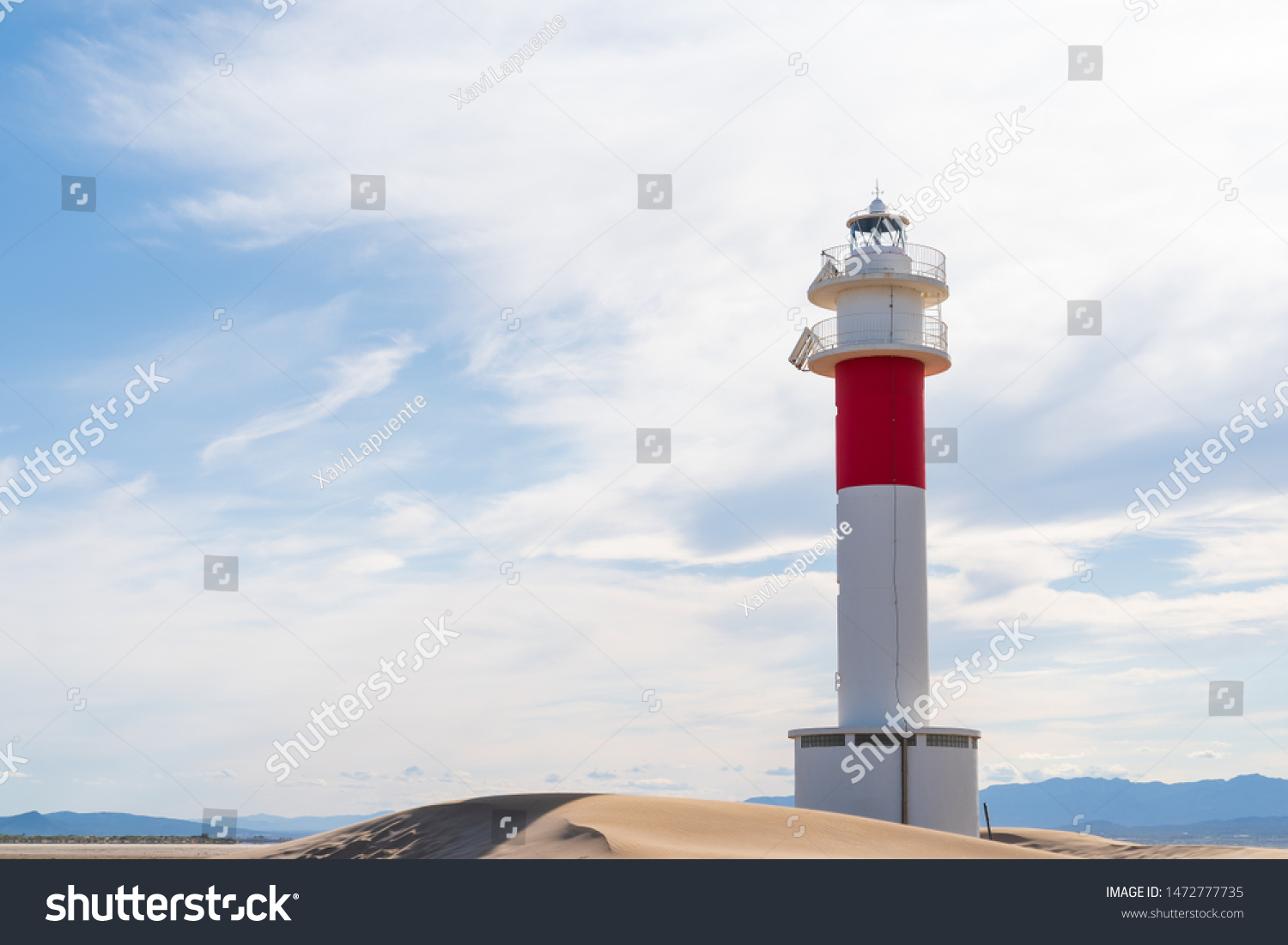 DELTA DEL EBRE, TARRAGONA, CATALUNYA, SPAIN - JUNE 5, 2019: Beach of "punta del fangar" lighthouse "far del fangar". #1472777735