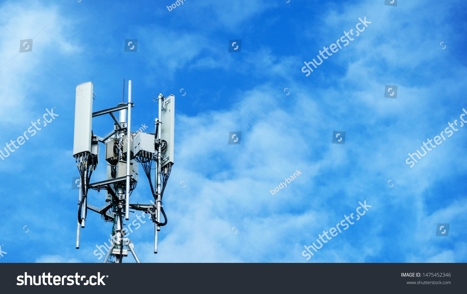 Technology on the top of the telecommunication. Cellular phone antennas on a building roof.Telecommunication mast television antennas.Receiving and transmitting stations. #1475452346