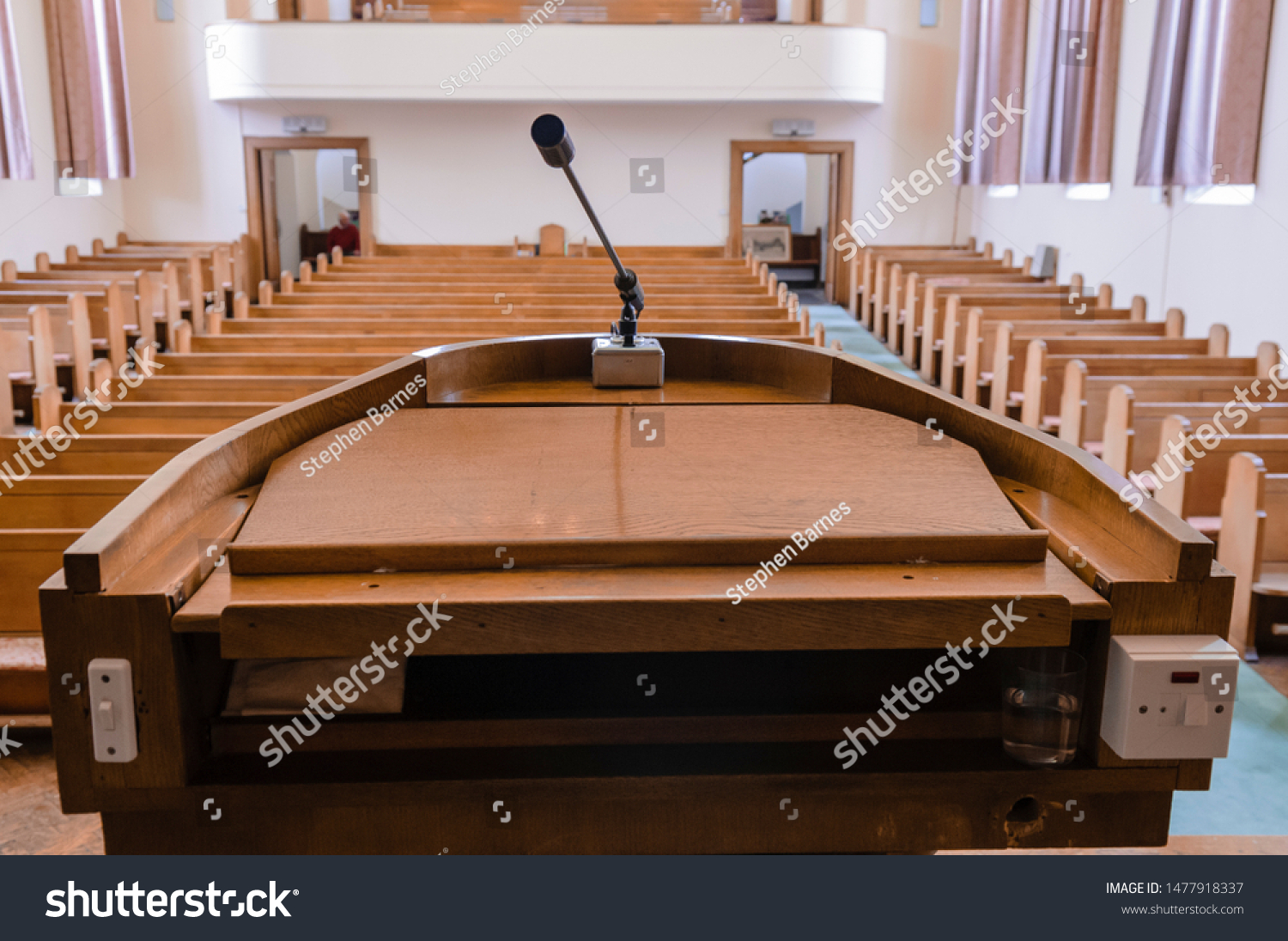 Pulpit at the a church with wooden pews #1477918337