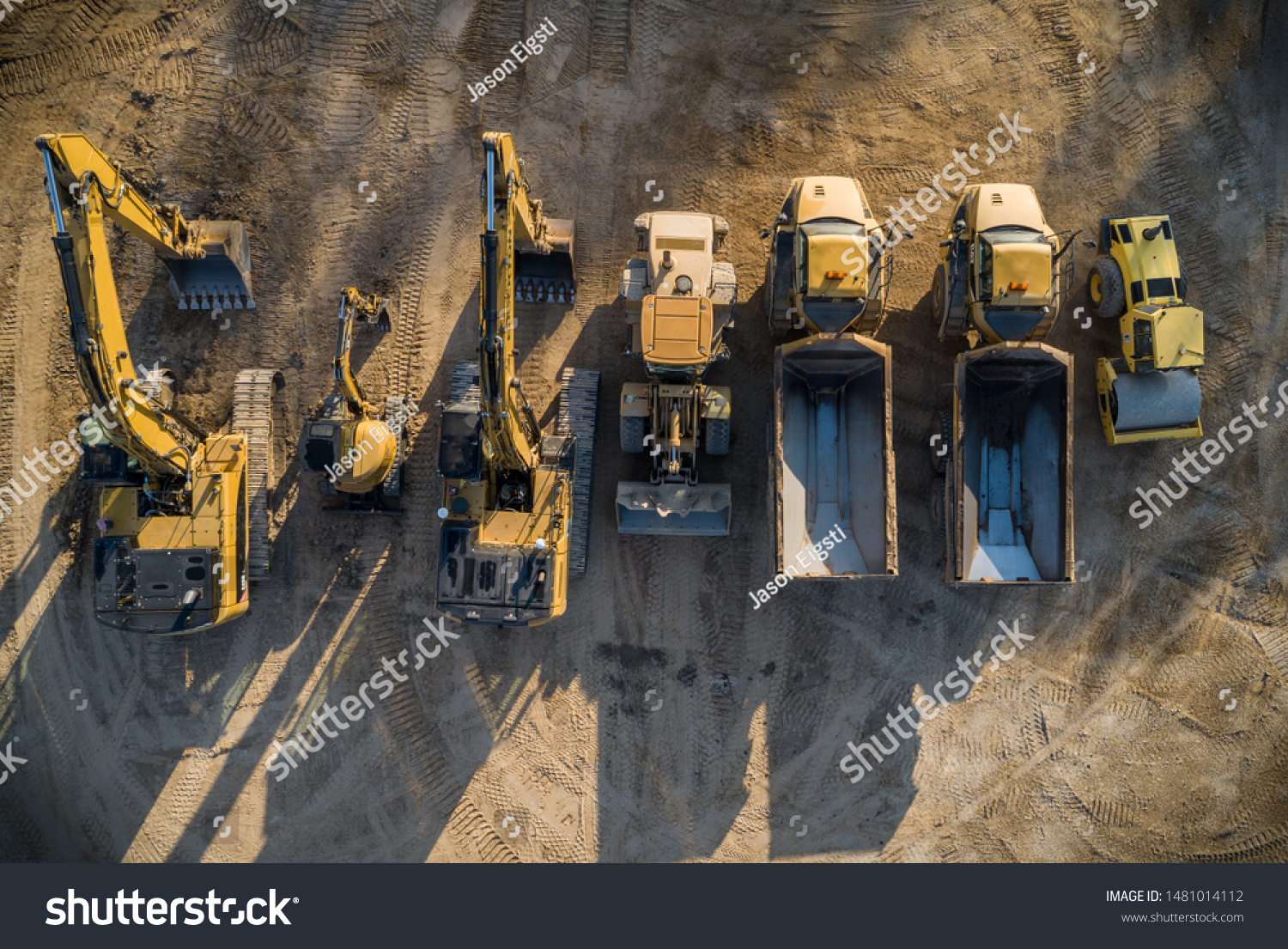 Construction dirt moving equipment lined up for the night. #1481014112