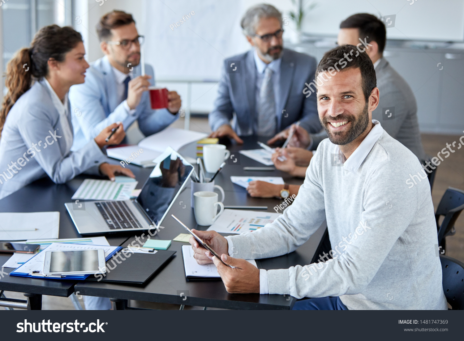 A portrait of a young smiling businessman  a meeting and presentation in the office. Business concept #1481747369