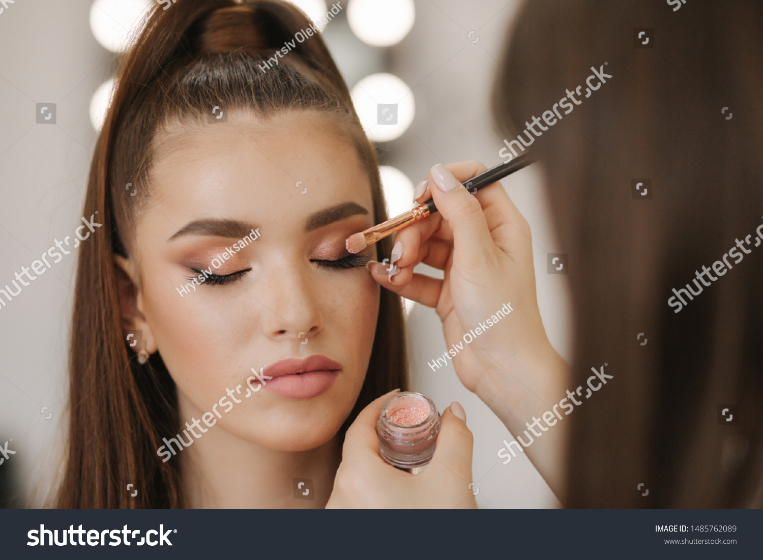 Makeup artist applies eye shadow, perfect evening makeup. Beauty redhead girl with perfect skin and freckles #1485762089