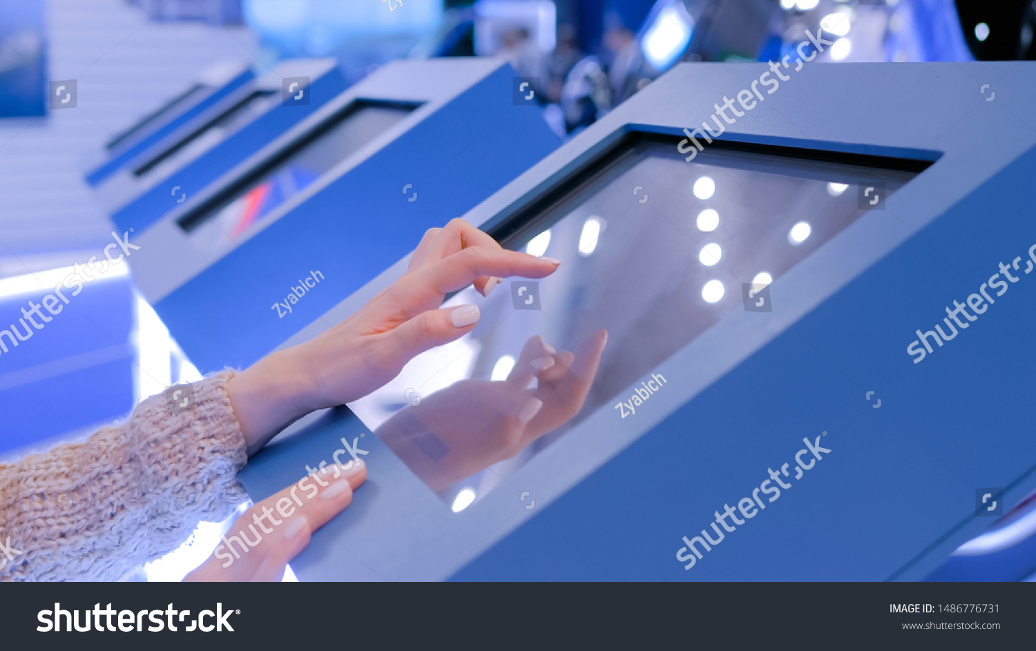 Education and technology concept - woman using interactive touchscreen display of electronic kiosk at technology exhibition #1486776731