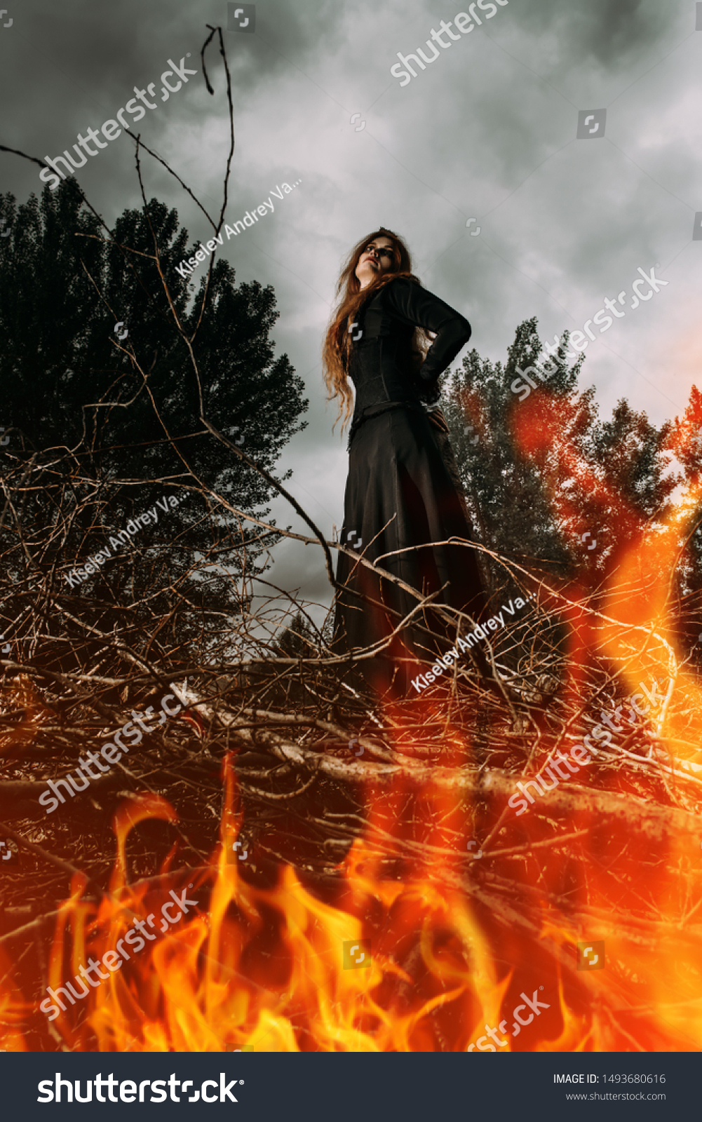 A portrait of an angry witch tied for incineration. Magic, dark force, spell.  #1493680616