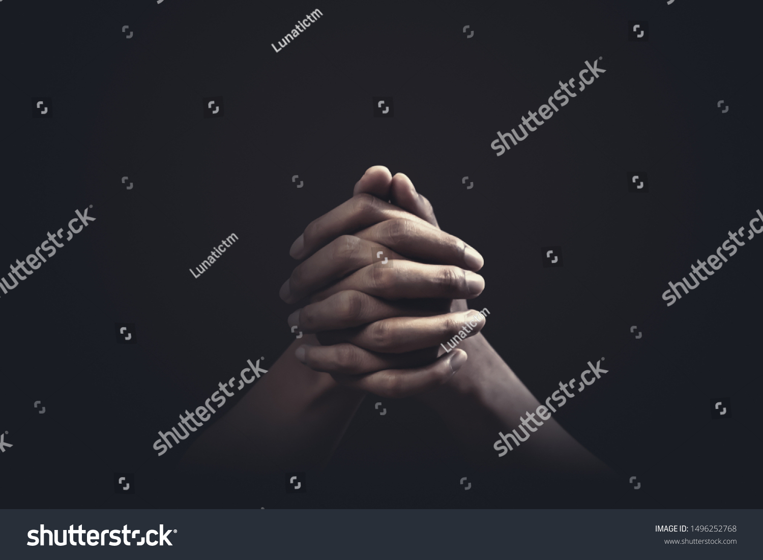 Praying hands with faith in religion and belief in God on dark background. Power of hope or love and devotion. #1496252768