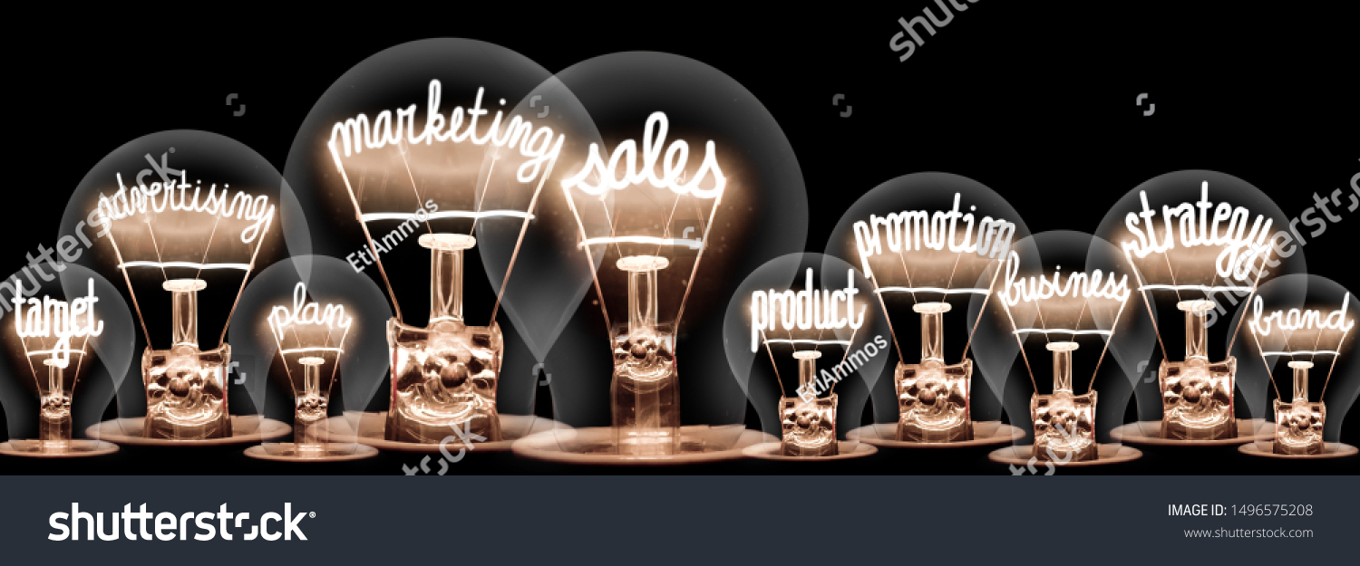 Photo of light bulbs with shining fibers in shapes of Marketing Sales, Advertising, Promotion and Strategy concept related words isolated on black background #1496575208