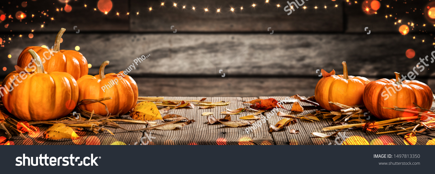 Mini Thanksgiving Pumpkins And Leaves On Rustic Wooden Table With Lights And Bokeh On Wood Background - Thanksgiving / Harvest Concept #1497813350