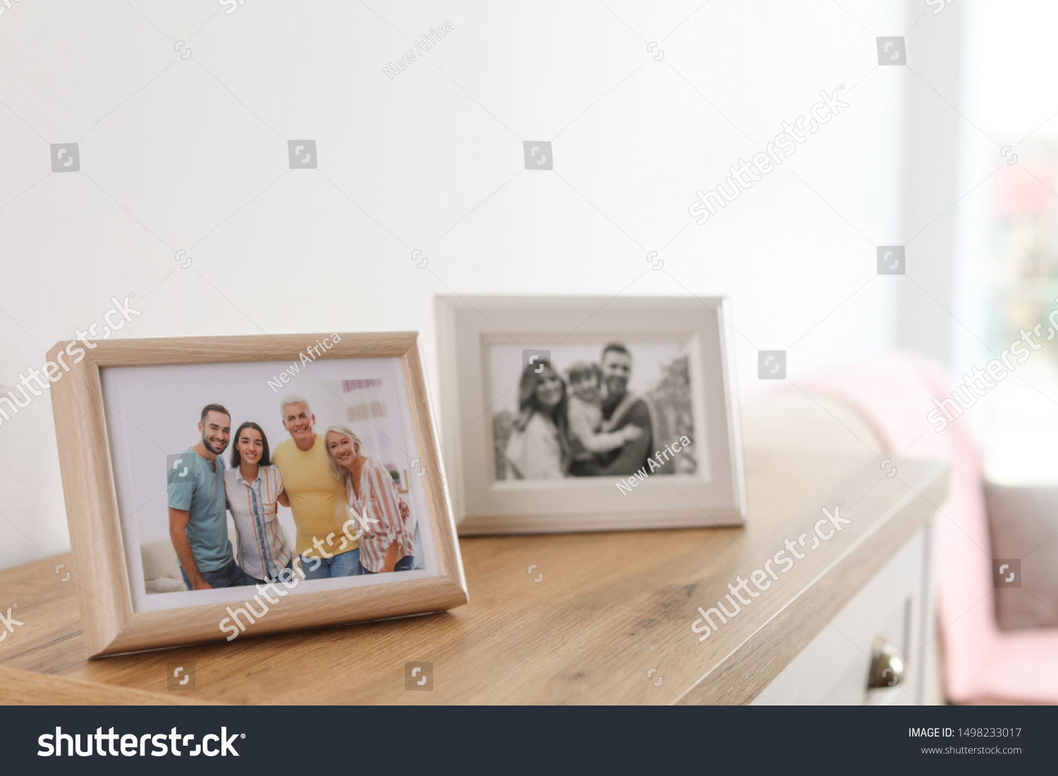 Family portraits in frames on cabinet indoors #1498233017
