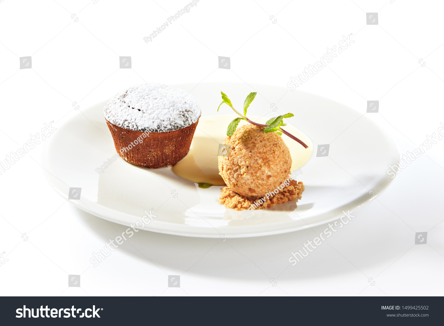Whole hot chocolate fondant with ice cream ball and condense milk on white plate isolated. Restaurant dessert with fresh brownie, muffin or small chocolate cake with crunchy rind and mellow filling #1499425502
