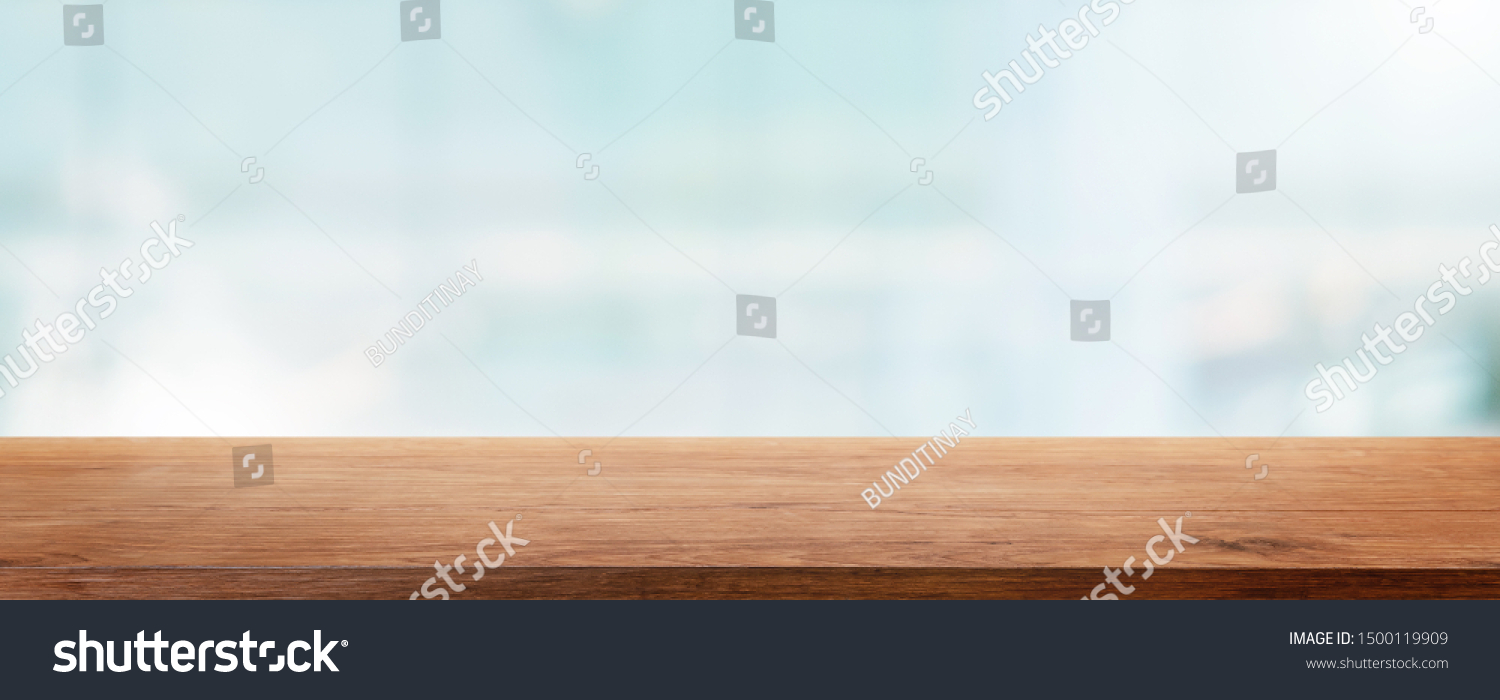 Empty wood table top and blur glass window wall building banner mock up abstract background - can used for display or montage your products. #1500119909