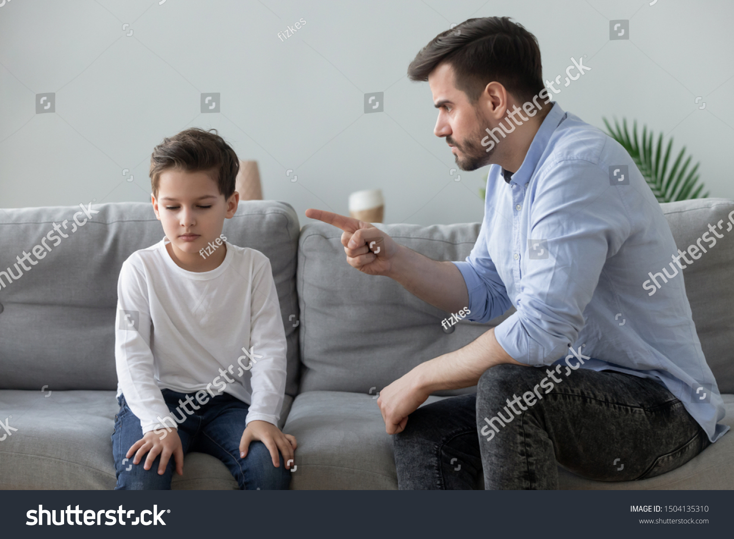 Angry mad father scolding lecturing sad preschool kid son for bad behavior at home, serious parent dad punish little upset guilty child boy pointing finger demand discipline, family conflicts concept #1504135310
