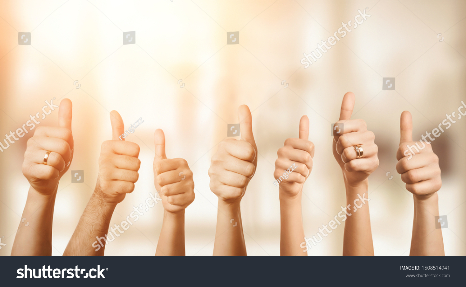 Close up of group of hands showing thumbs up over defocused background with copy space #1508514941