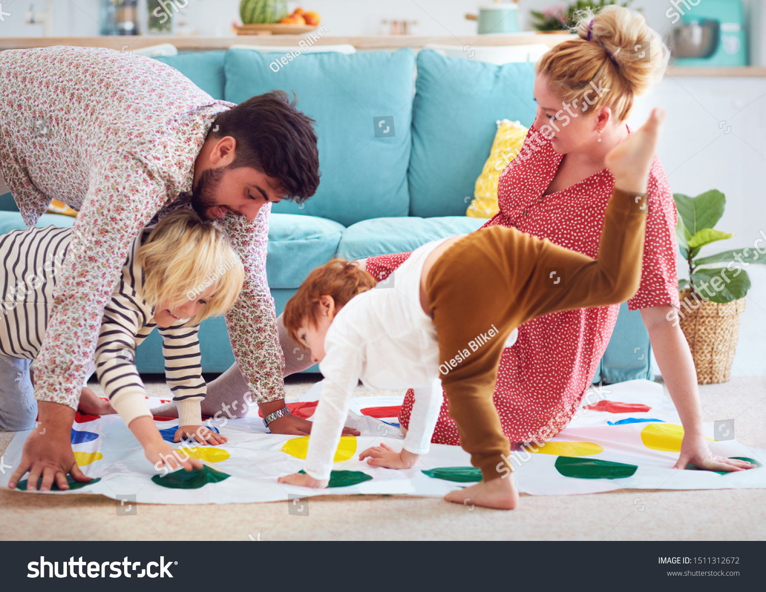 happy family having fun together, playing twister game at home #1511312672