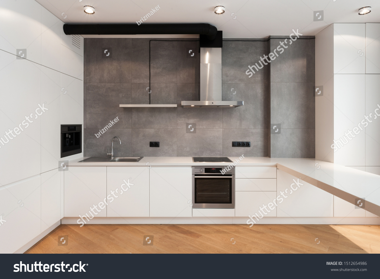 White cupboard with built in household appliance, electric stove, oven, sink on worktop, wooden laminate on floor and extractor hood on grey wall. House with modern interior at contemporary kitchen #1512654986