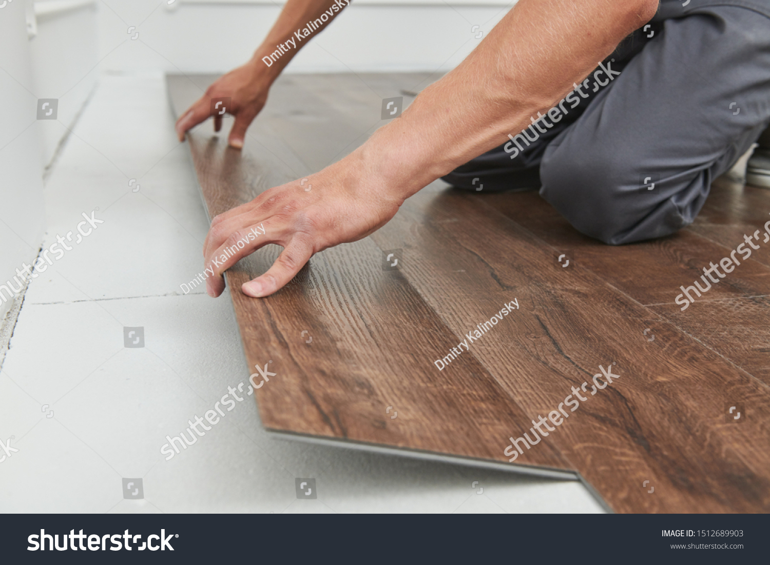 worker joining vinyl floor covering at home renovation #1512689903