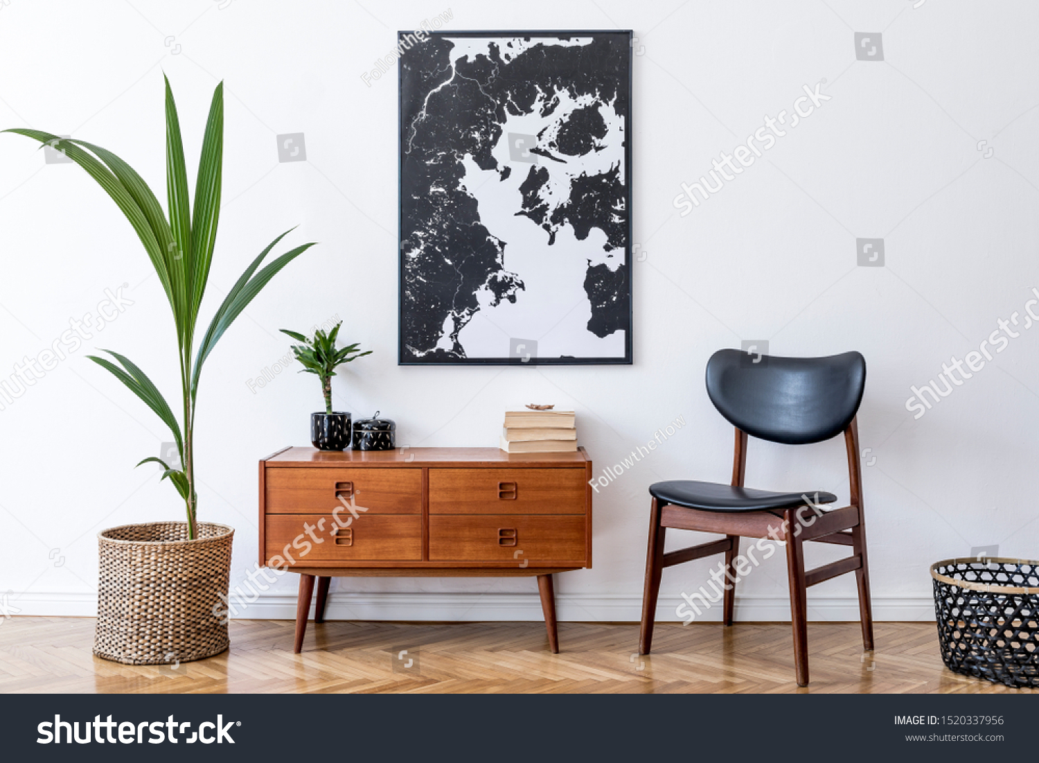 Stylish interior design of living room with wooden retro commode, chair, tropical plant in rattan pot, basket and elegant personal accessories. Mock up poster frame on the wall. Template. Home decor. #1520337956