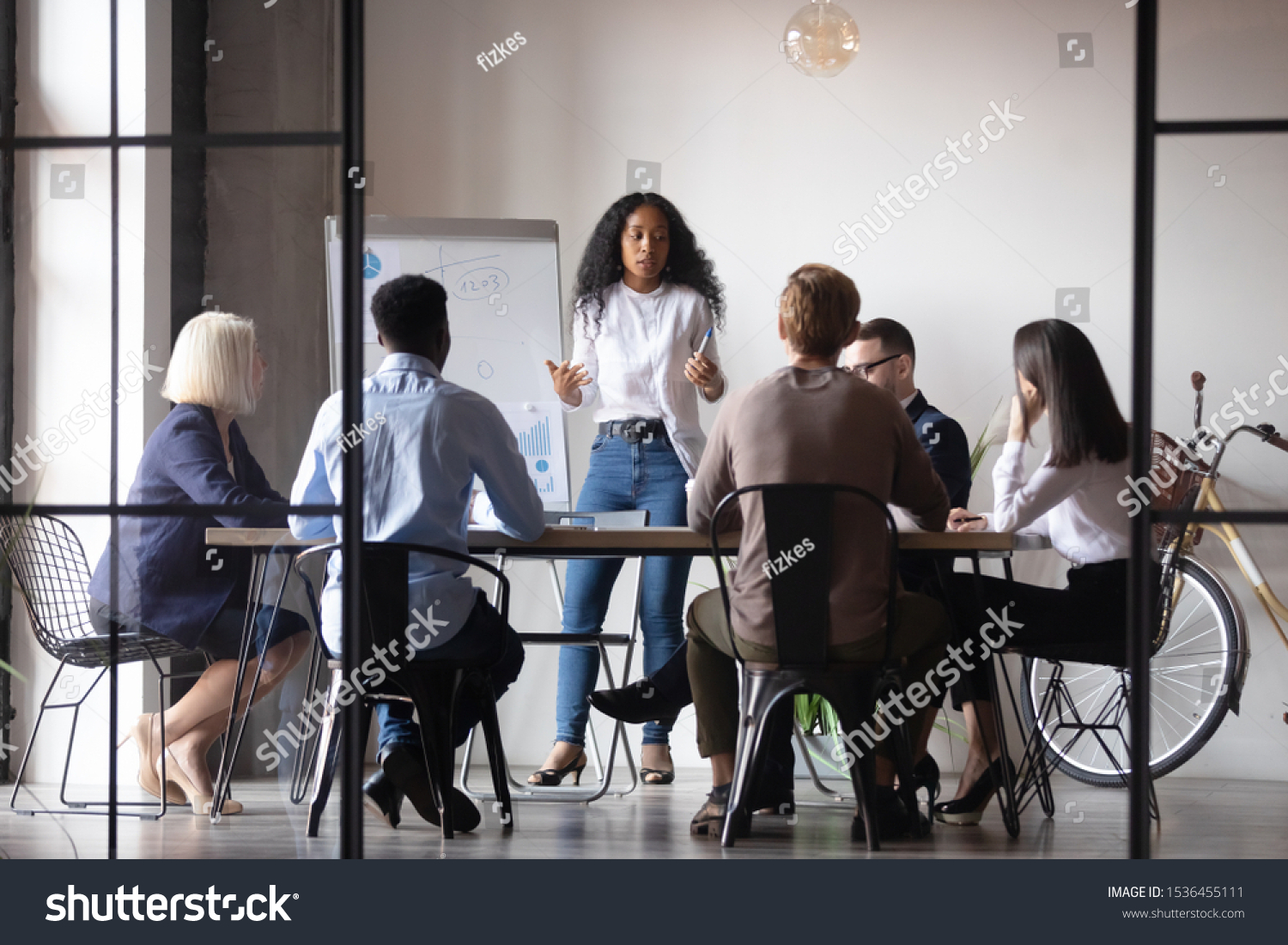 Confident african businesswoman presenter coach give corporate whiteboard presentation training multiracial people group explain project at team briefing staff conference, business education concept #1536455111