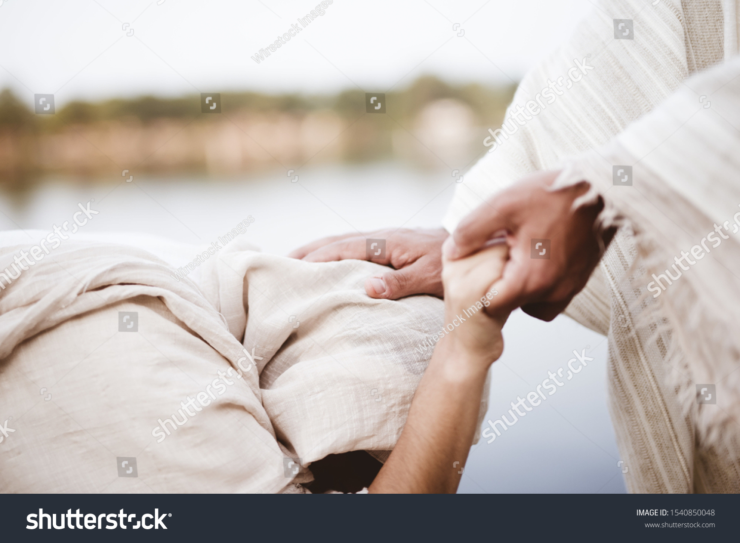 A closeup shot of Jesus Christ healing the female with a blurred background #1540850048