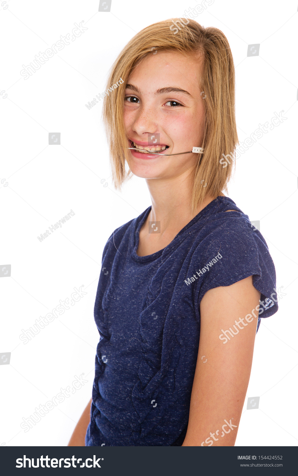 A happy teenage girl wearing corrective headgear for her teeth. #154424552