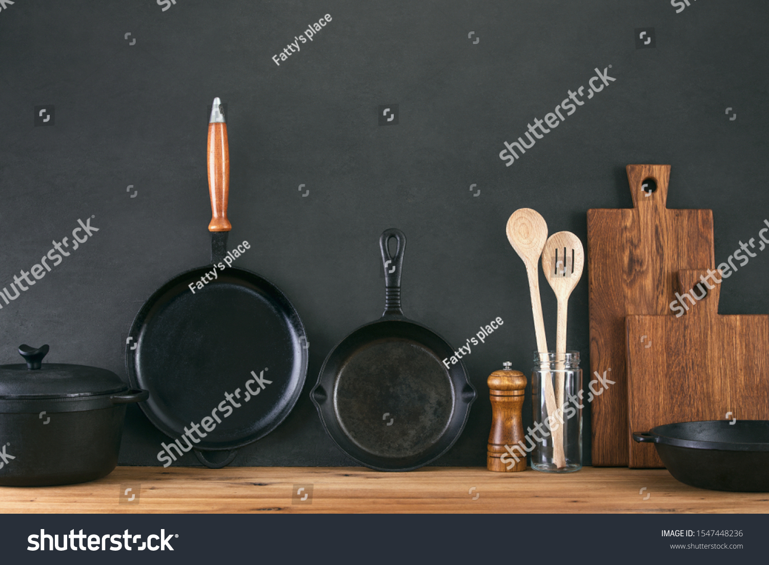 Kitchen utensils dark background with cast iron black kitchenware, front view of home kitchen table top #1547448236
