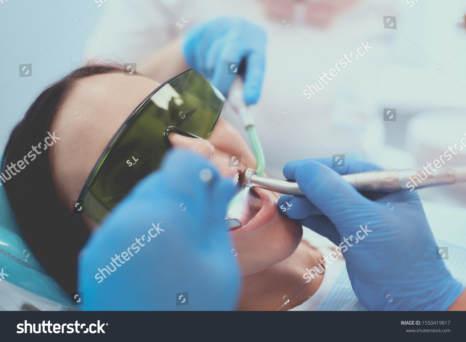 Dental team and patient at dentist's surgery #1550419817
