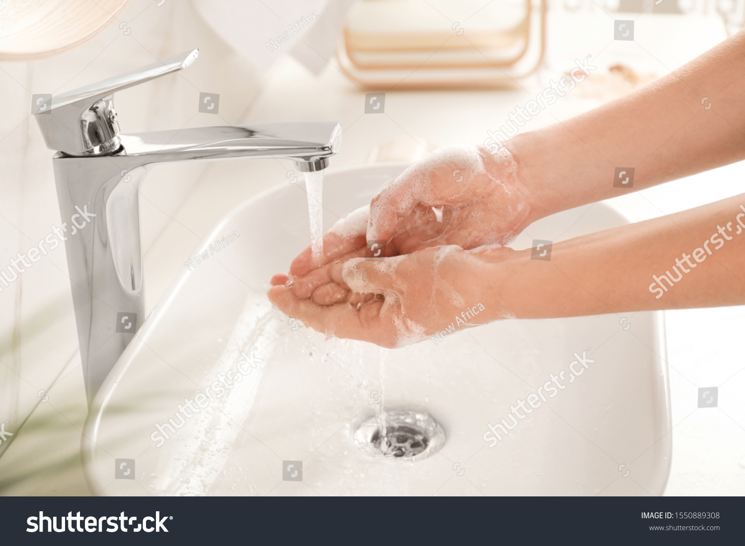Young woman washing hands with soap over sink in bathroom, closeup #1550889308