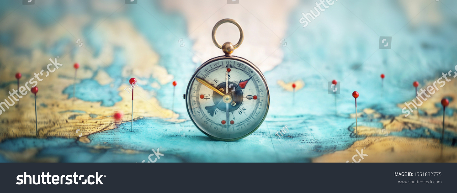 Magnetic compass  and location marking with a pin on routes on world map. Adventure, discovery, navigation, communication, logistics, geography, transport and travel theme concept background. #1551832775