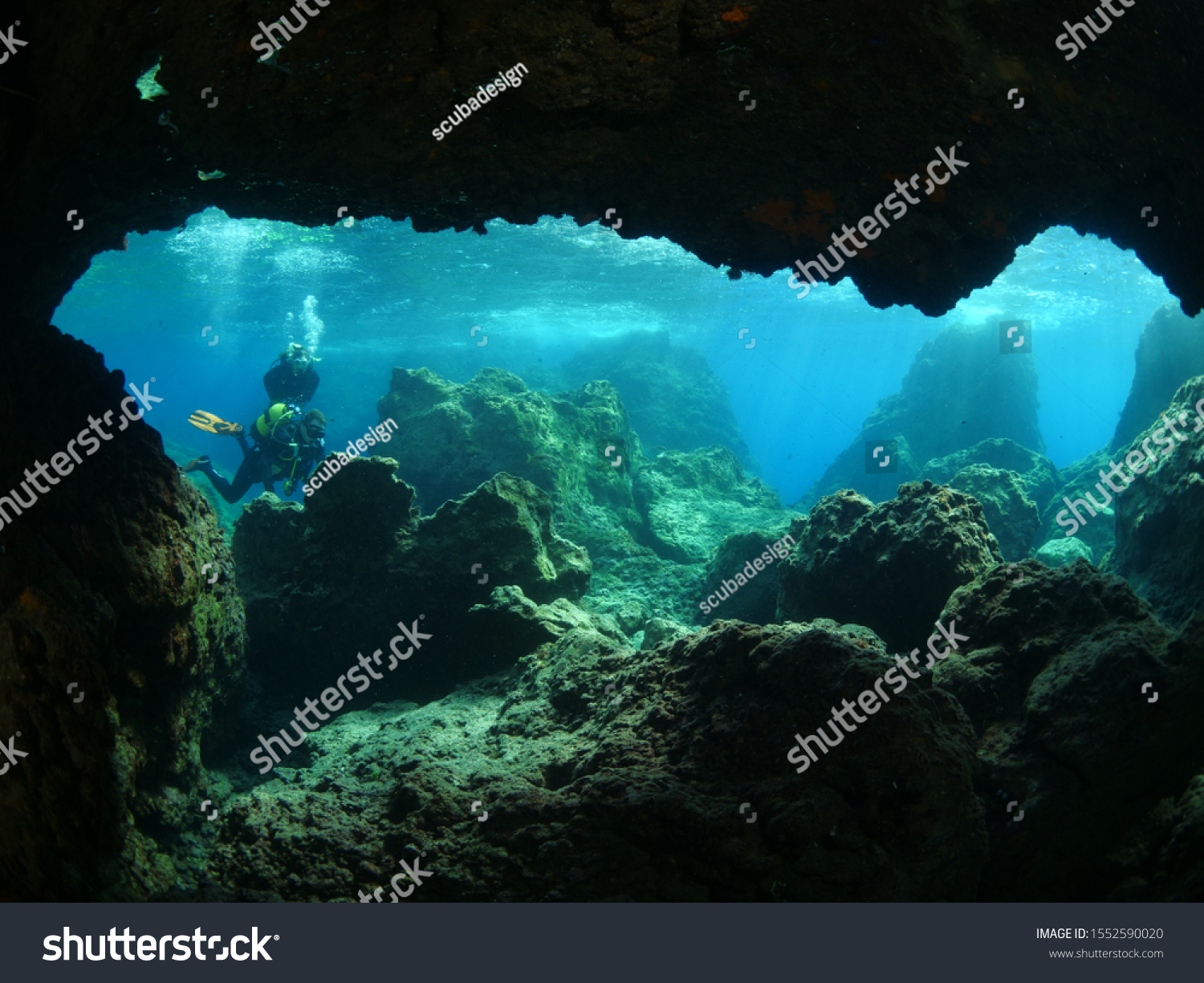 scuba divers are exploring the caves and caverns underwater #1552590020