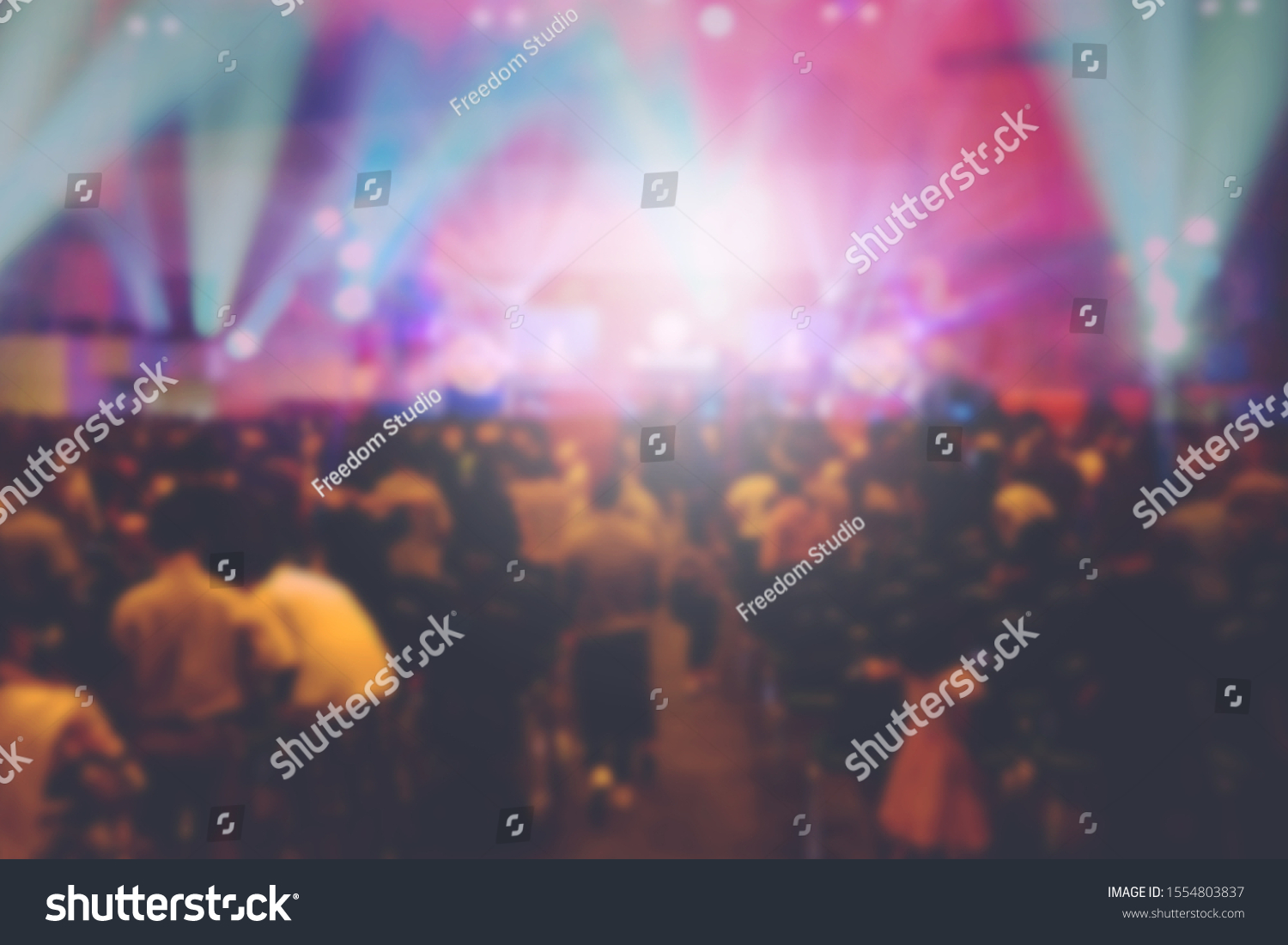 Blurred of Christian Congregation Worship God together in Big Church hall in front of music stage and light effected. #1554803837