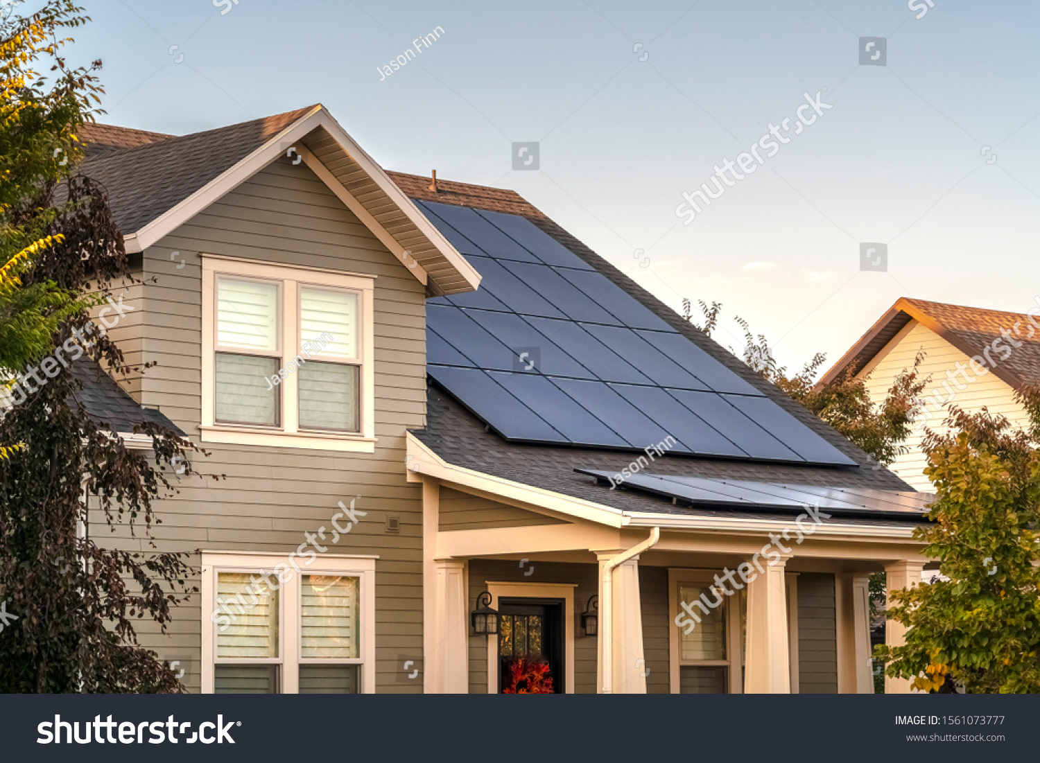 Solar photovoltaic panels on a house roof #1561073777