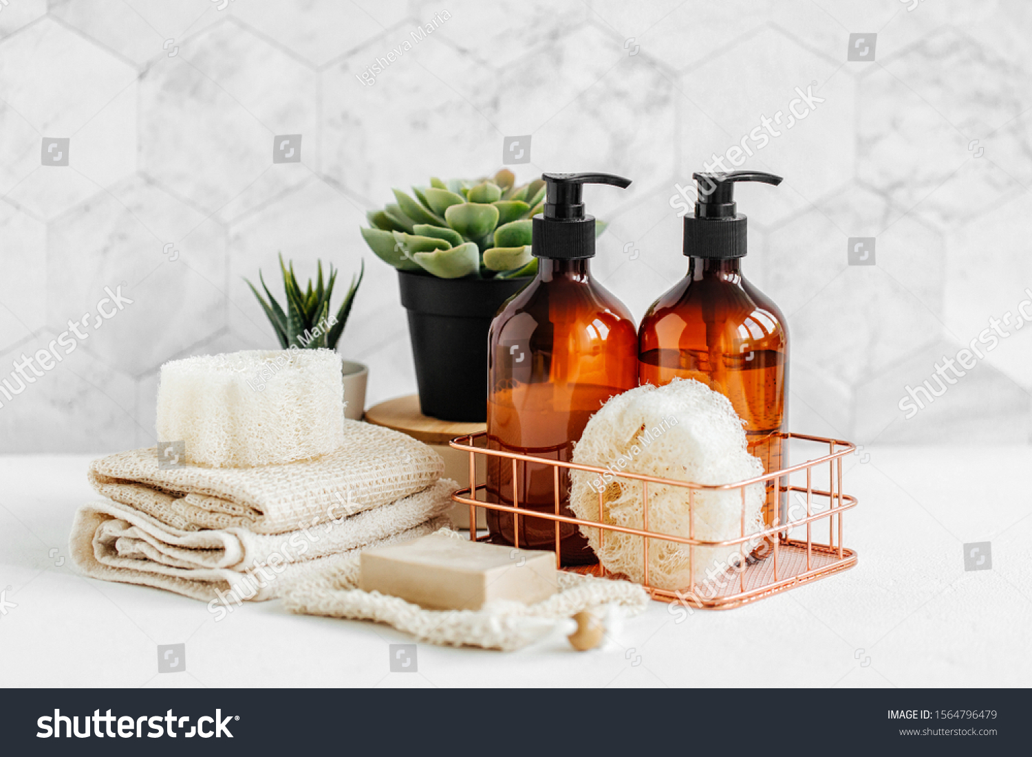 Soap and shampoo bottles and cotton towels with green plant on white table inside a bathroom background. #1564796479