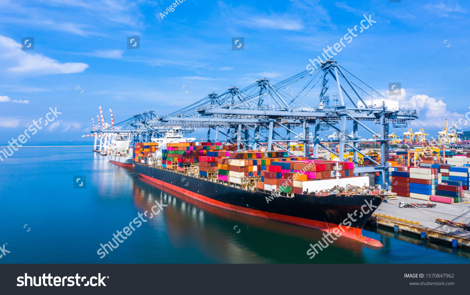 Container ship at industrial port in import export business logistic and transportation of international by container ship in the sea, Container loading in cargo freight ship with industrial crane. #1570847962