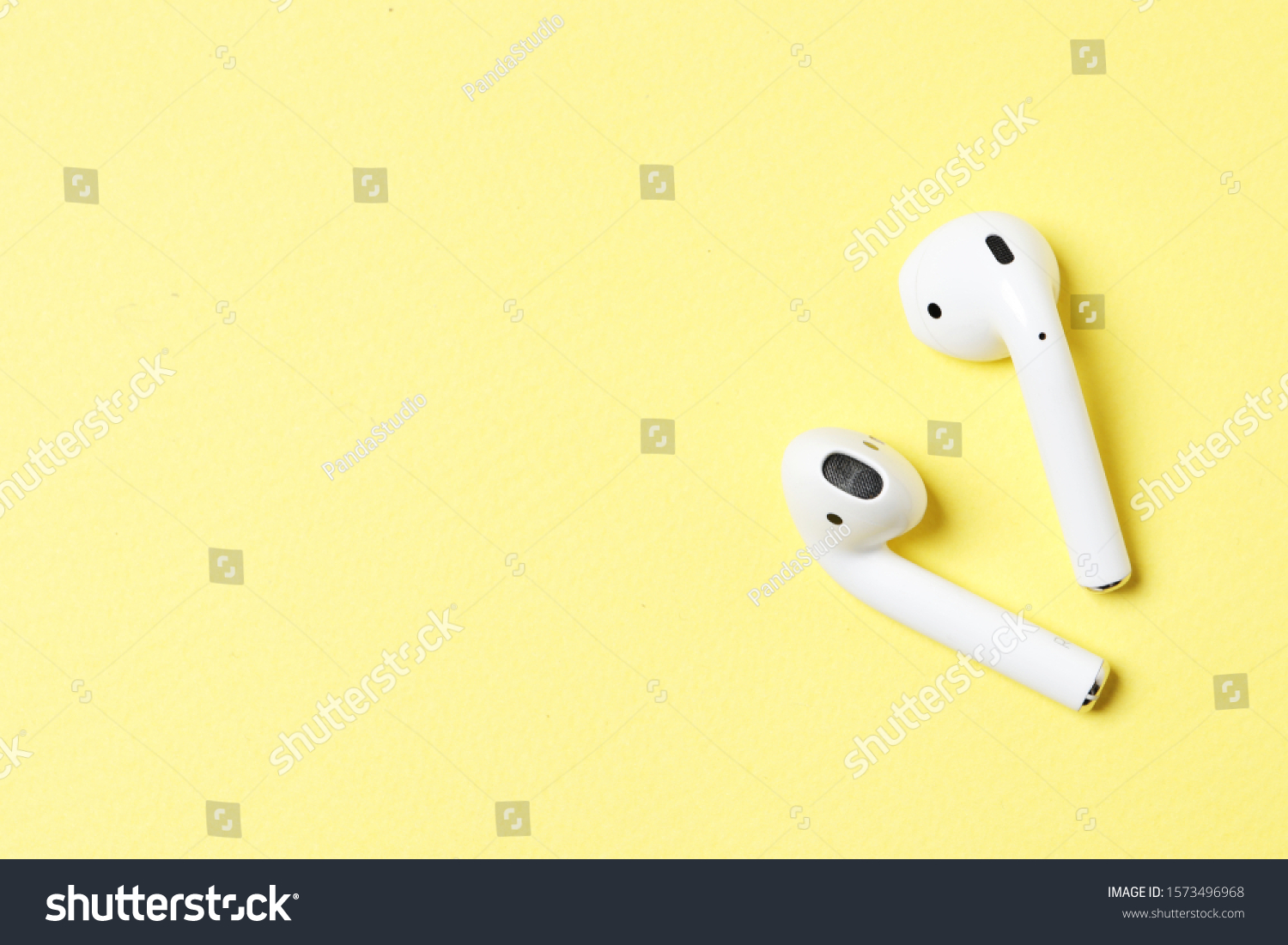 Wireless headphones on a yellow background with place for text. #1573496968