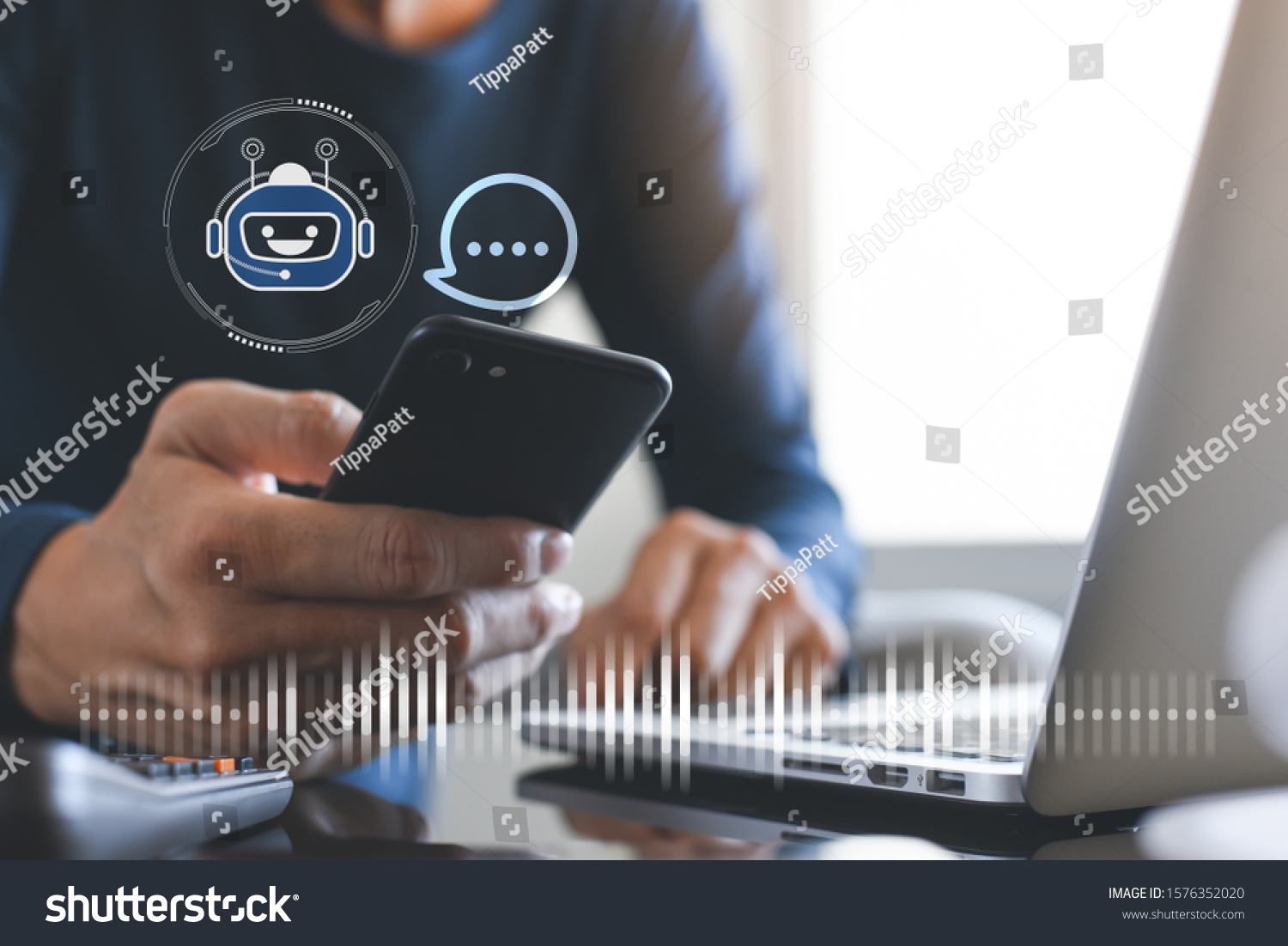 Chatbot assistant conversation, Ai Artificial Intelligence technology concept. Casual business man chatting with chatbot via mobile smart phone application while working on laptop computer #1576352020