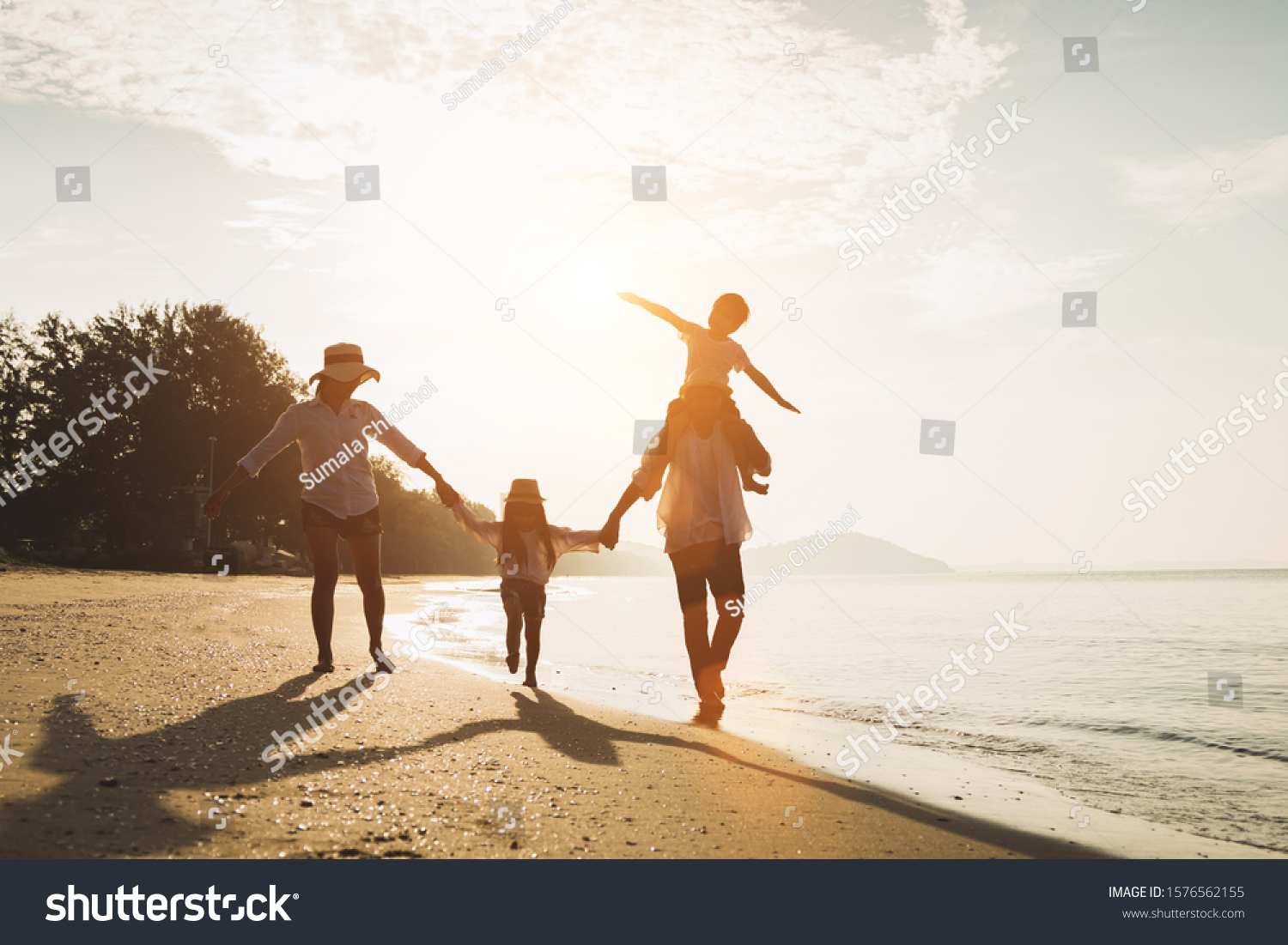 Happy family travel on beach in holiday,Summer vacations. Happy family are having fun on a tropical beach in sunset. Father and mother and children playing together outdoor on beach. #1576562155