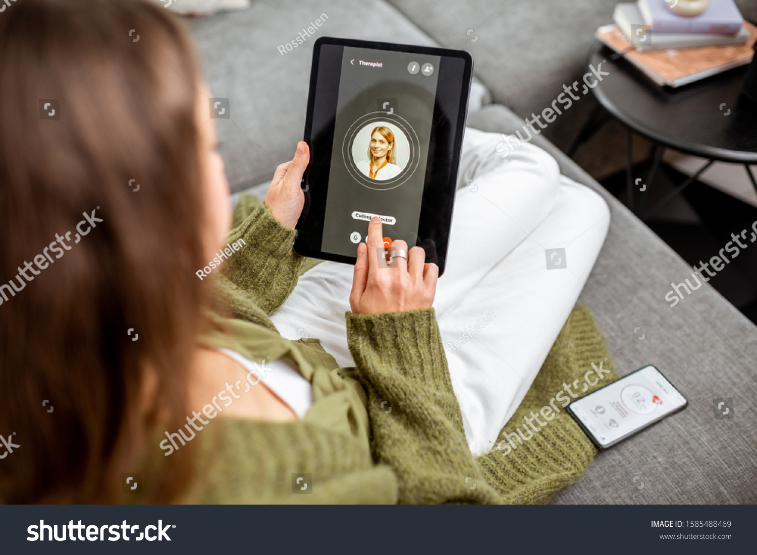 Woman making video call to a doctor using digital tablet, feeling bad at home. Concept of telemedicine and patient counseling online #1585488469