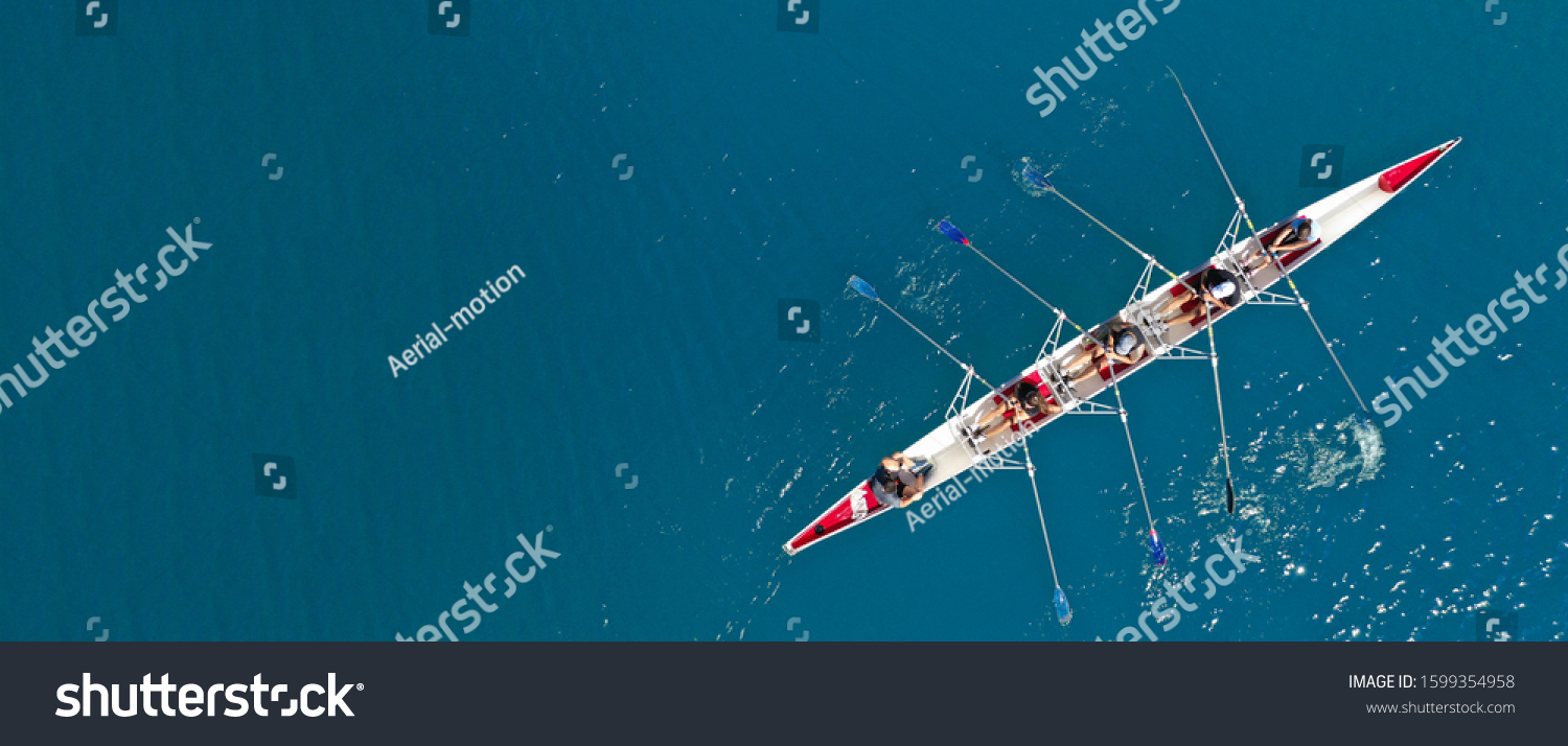 Aerial drone ultra wide top down photo of sport canoe with young team of athletes practising in deep blue open ocean sea #1599354958