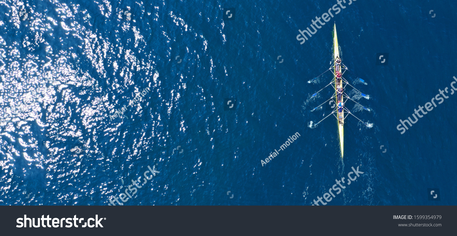 Aerial drone ultra wide photo of sport canoe with young team of athletes practising in deep blue open ocean sea #1599354979