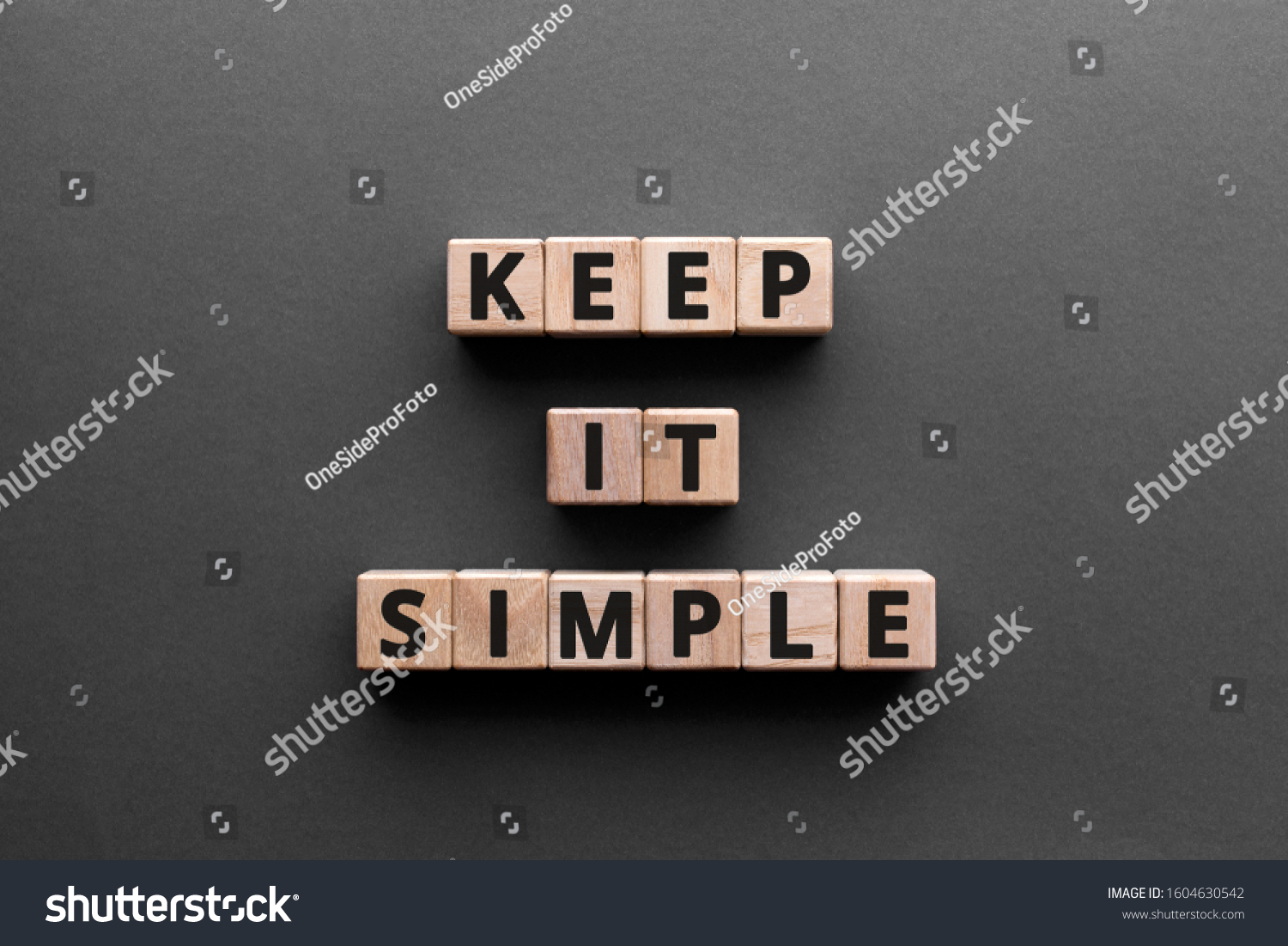 Keep it simple - word from wooden blocks with letters, to make something easy, keep it simple concept, gray background #1604630542