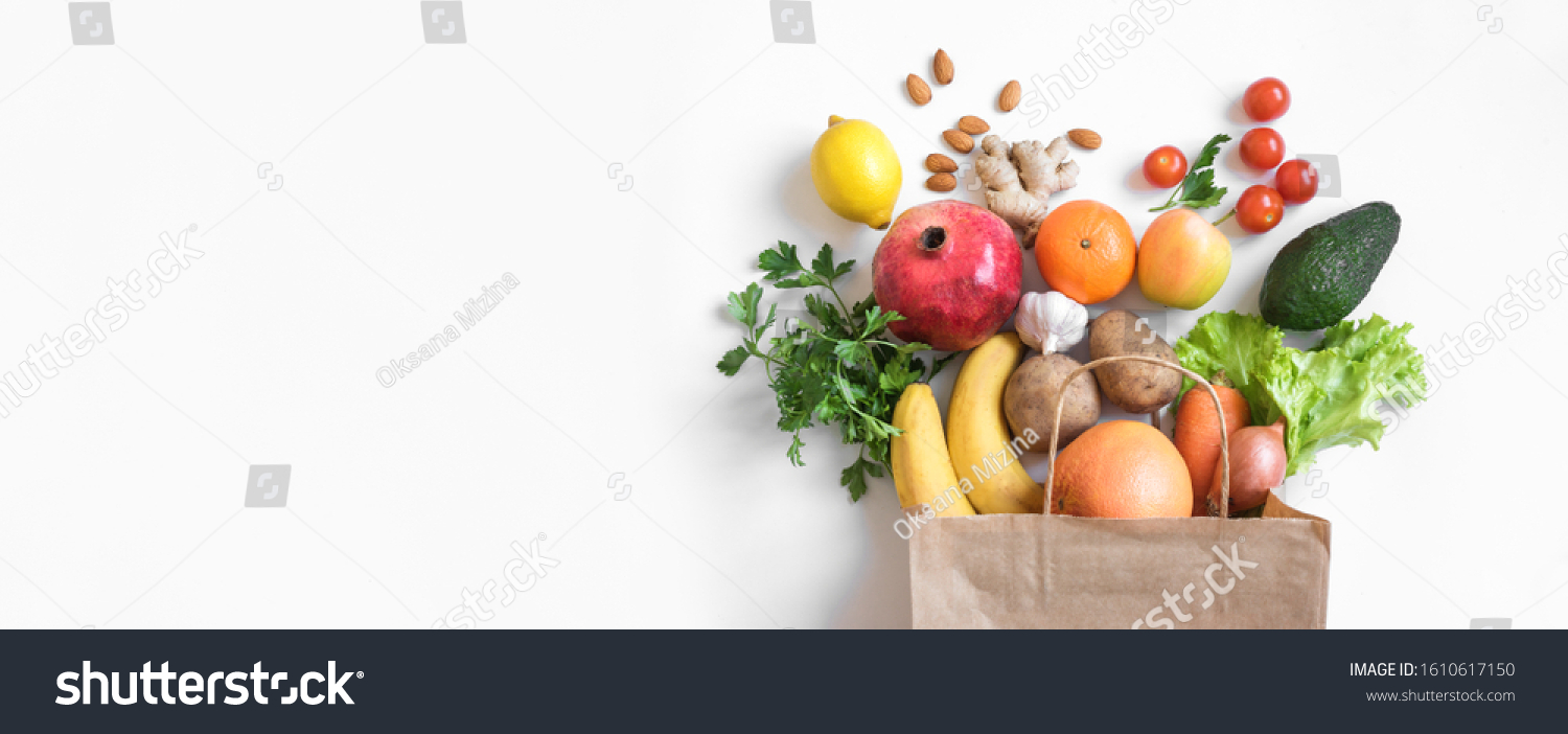 Healthy food background. Healthy vegan vegetarian food in paper bag vegetables and fruits on white, copy space, banner. Shopping food supermarket and clean vegan eating concept. #1610617150