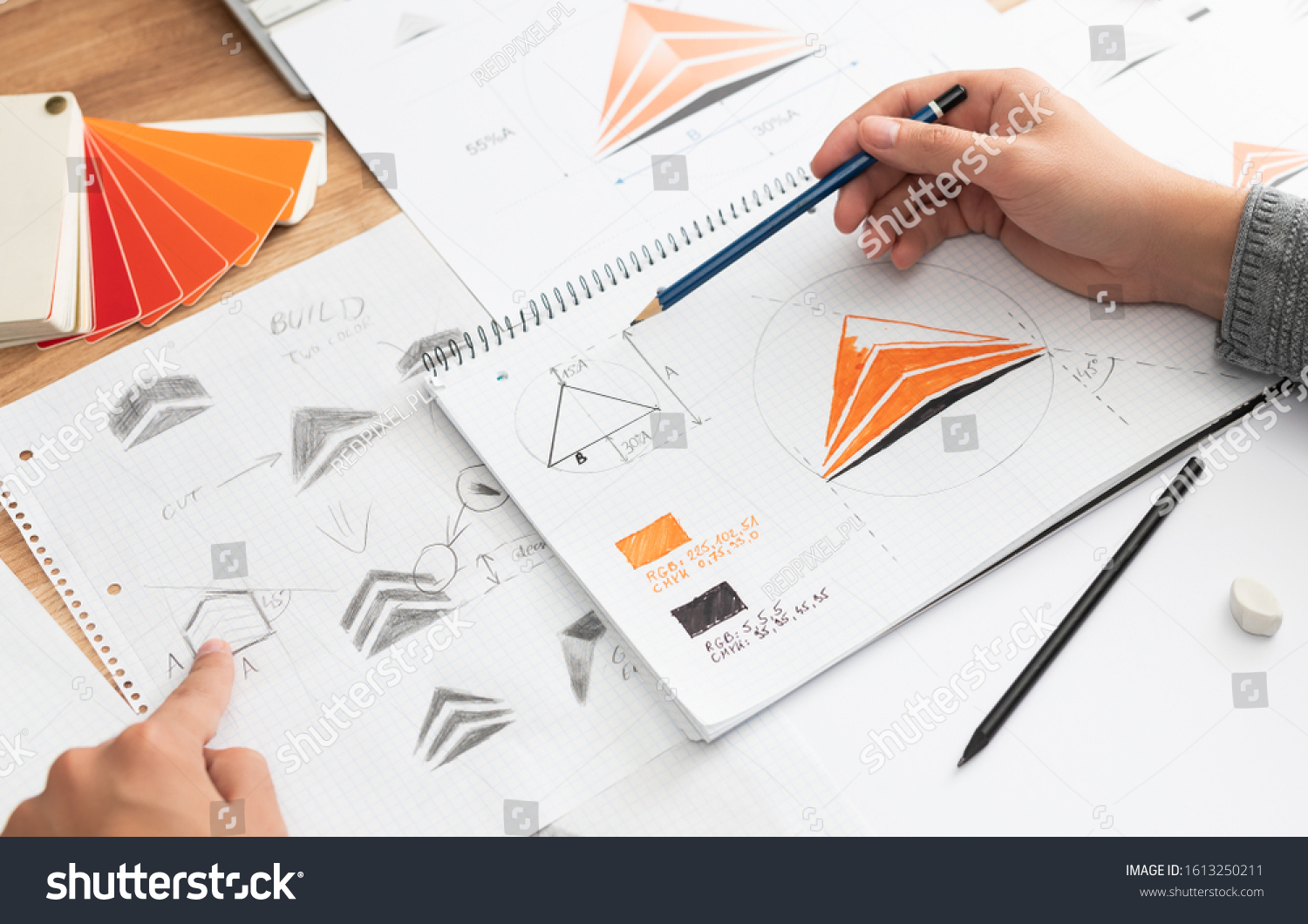 Graphic designer drawing sketches logo design. The concept of a new brand. Professional creative occupation with idea. #1613250211