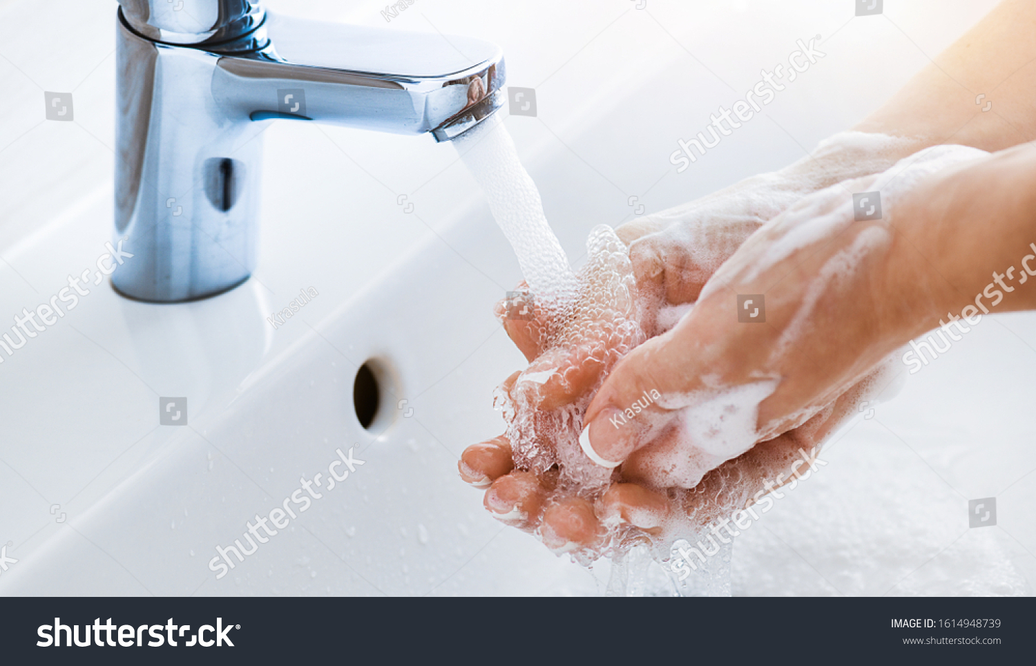 Woman use soap and washing hands under the water tap. Hygiene concept hand detail. #1614948739