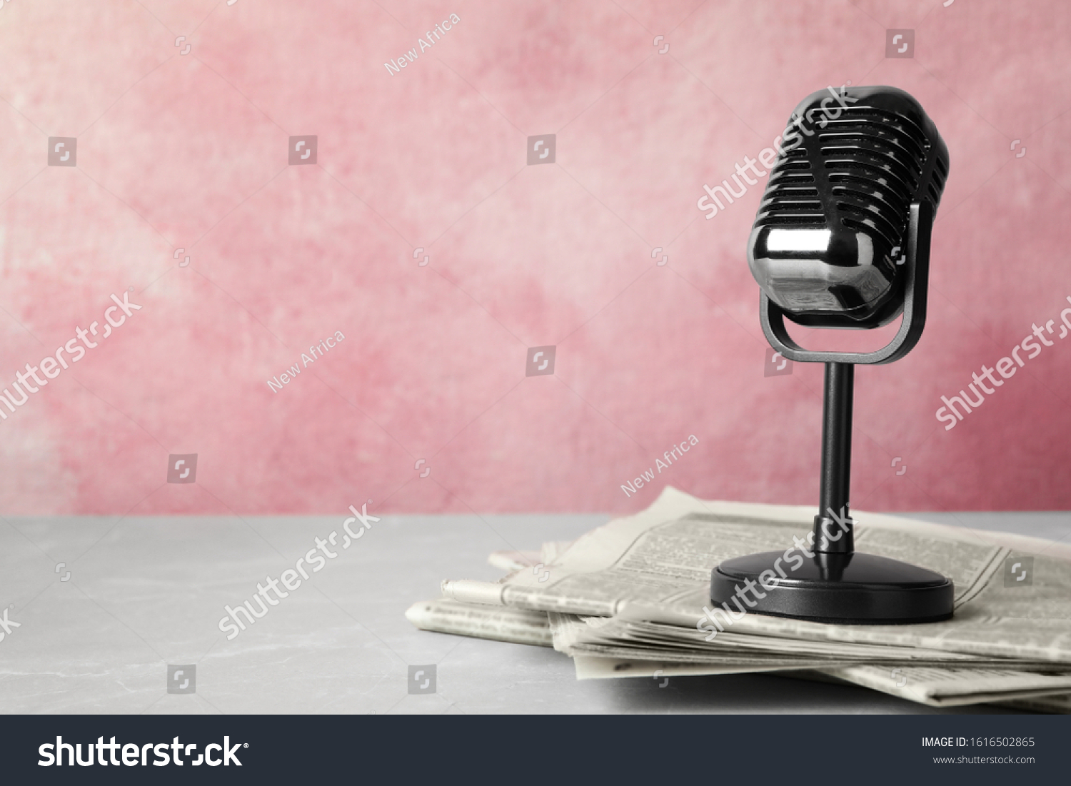 Newspapers and vintage microphone on table, space for text. Journalist's work #1616502865