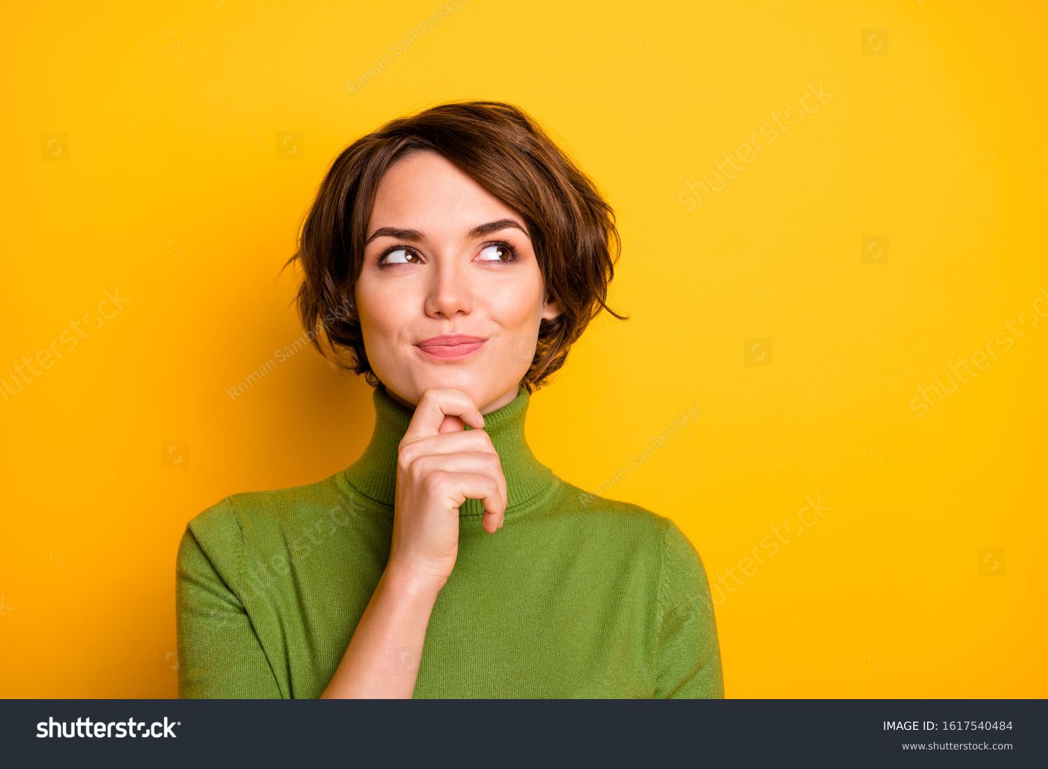 Closeup photo of amazing short hairdo lady looking up empty space deep thinking creative person arm on chin wear casual green turtleneck isolated yellow color background #1617540484